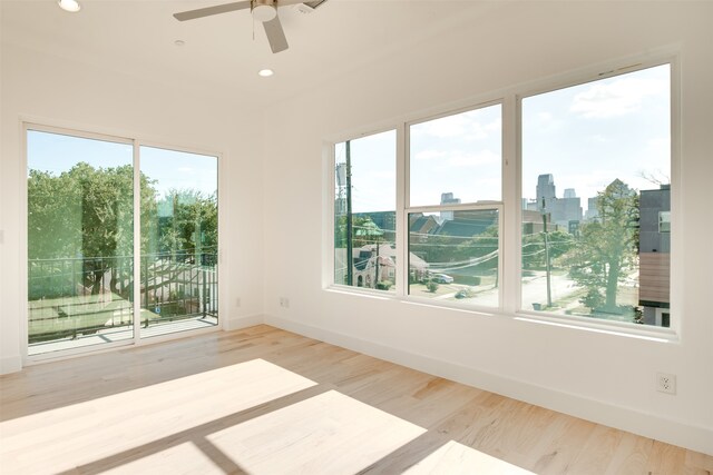 interior space with hardwood / wood-style flooring, a healthy amount of sunlight, and ceiling fan