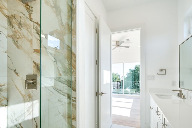 bathroom with vanity, ceiling fan, wood-type flooring, and a shower with door