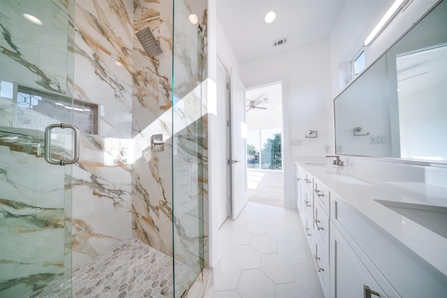 full bath featuring visible vents, tile patterned flooring, double vanity, a sink, and a marble finish shower