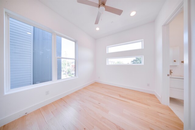 empty room featuring light wood-type flooring and ceiling fan