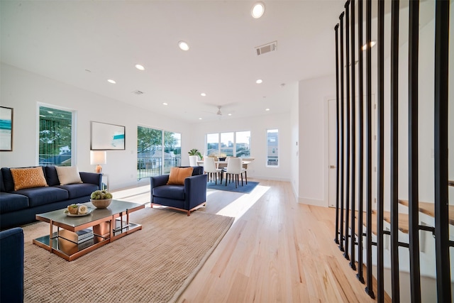 living area featuring recessed lighting, light wood finished floors, baseboards, and visible vents