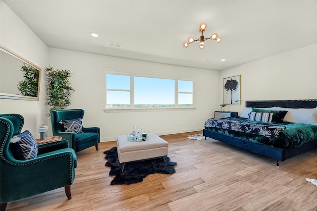 bedroom featuring a chandelier and light wood-type flooring