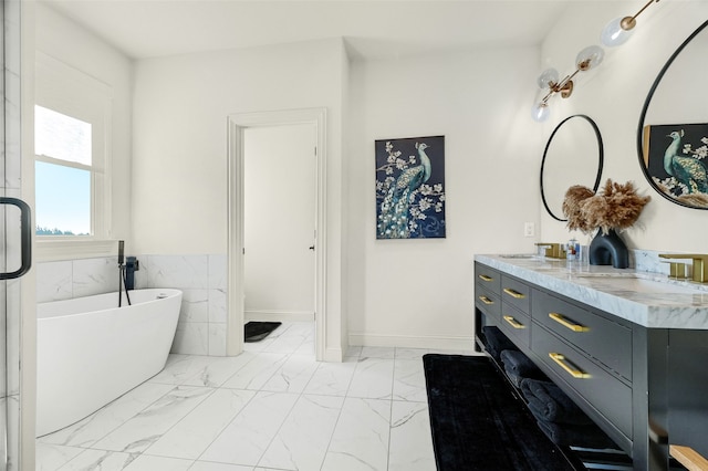 bathroom featuring a bathing tub, vanity, and tile walls