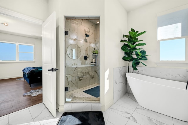 bathroom featuring independent shower and bath and hardwood / wood-style floors