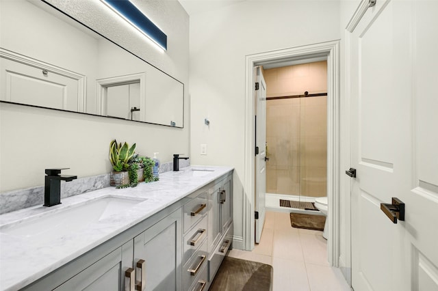 bathroom featuring vanity, a tile shower, toilet, and tile patterned flooring