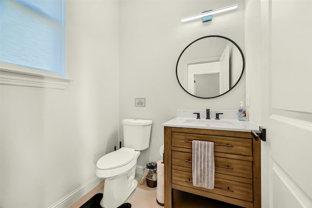 bathroom with vanity, toilet, and tile patterned floors