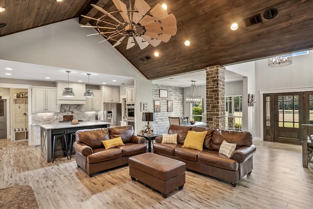 living room with high vaulted ceiling, light hardwood / wood-style floors, and plenty of natural light