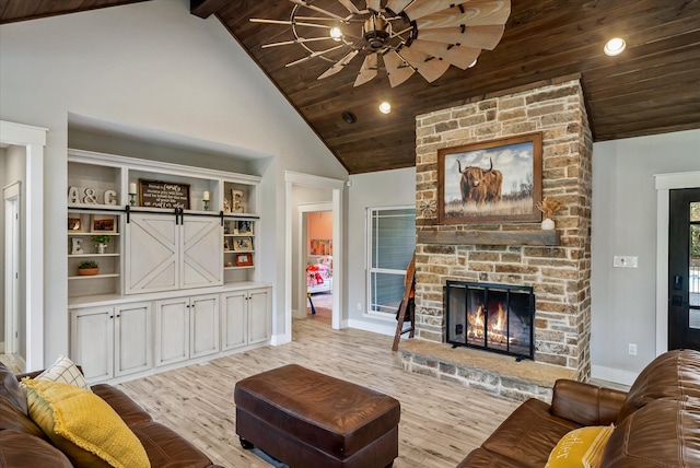 living room with high vaulted ceiling, wood ceiling, a barn door, and light hardwood / wood-style floors