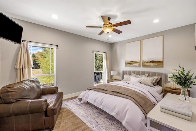 bedroom with light hardwood / wood-style floors, ceiling fan, and access to exterior