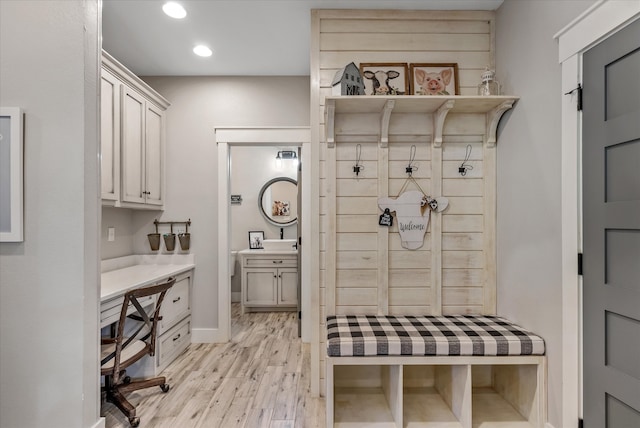 mudroom with light hardwood / wood-style floors