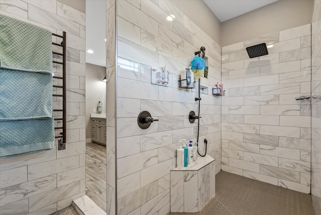 bathroom with vanity and a tile shower