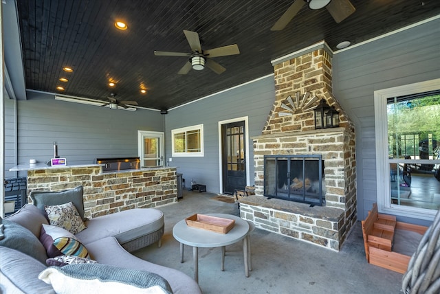 view of patio / terrace with an outdoor living space with a fireplace and ceiling fan