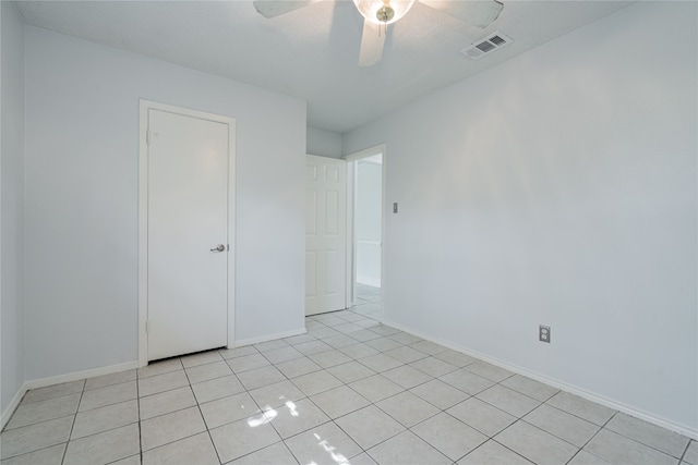 unfurnished room with ceiling fan and light tile patterned floors