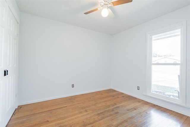 unfurnished room featuring ceiling fan, a textured ceiling, and light wood-type flooring