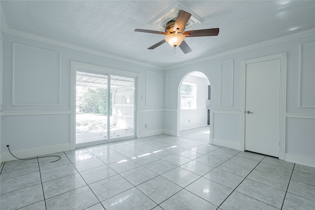 unfurnished room featuring ornamental molding, light tile patterned floors, and ceiling fan