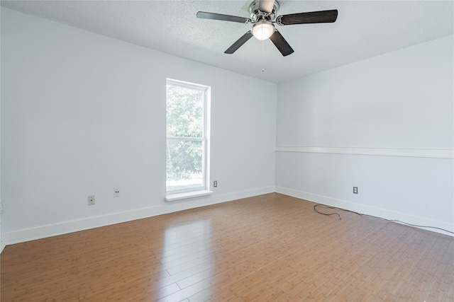 unfurnished room featuring a textured ceiling, wood-type flooring, and ceiling fan