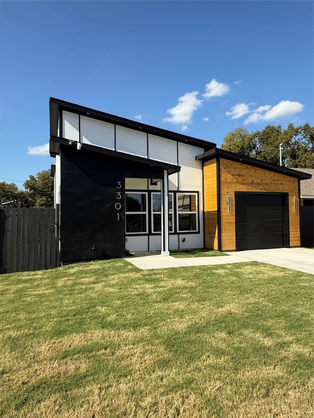 contemporary home with a front yard and a garage