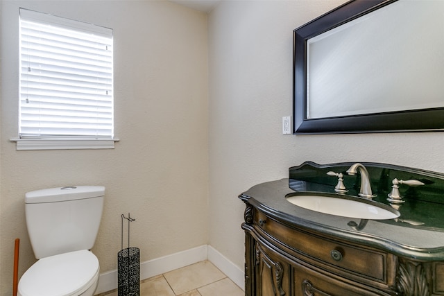 bathroom with toilet, tile patterned flooring, and vanity