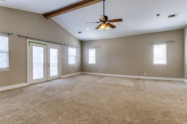 carpeted spare room featuring ceiling fan, french doors, and vaulted ceiling with beams