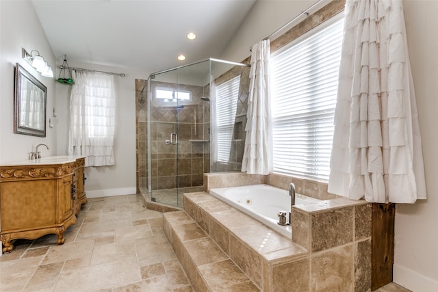 bathroom with vanity and shower with separate bathtub