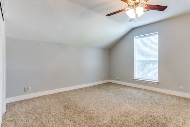 additional living space with ceiling fan, vaulted ceiling, carpet flooring, and a healthy amount of sunlight