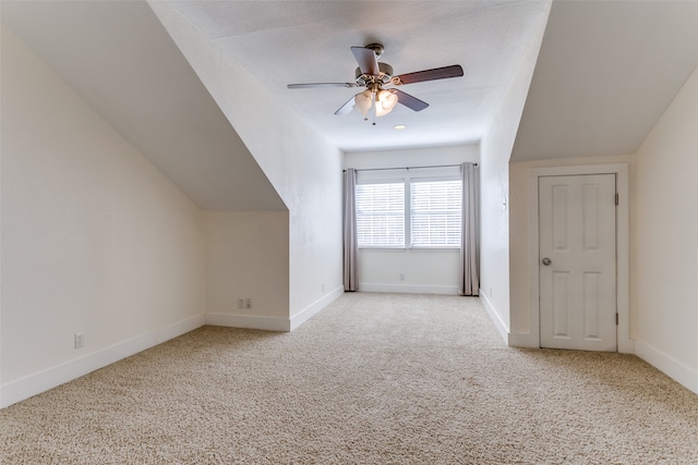 bonus room featuring ceiling fan and light colored carpet