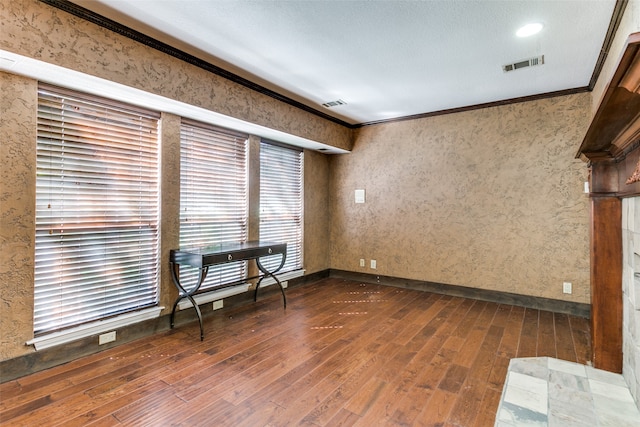 empty room with dark hardwood / wood-style floors and ornamental molding