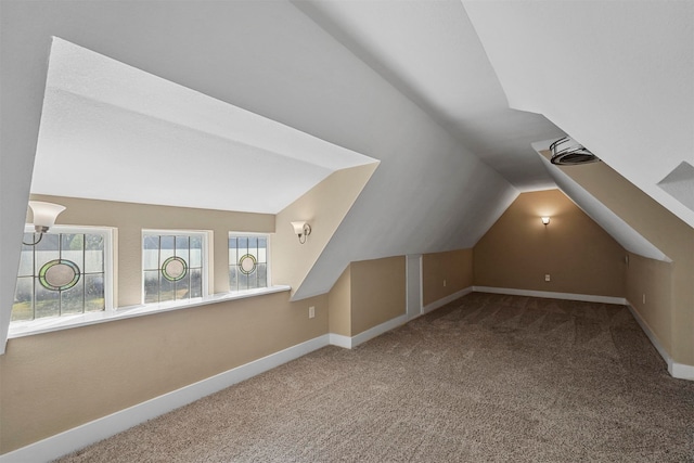 bonus room featuring carpet flooring and lofted ceiling