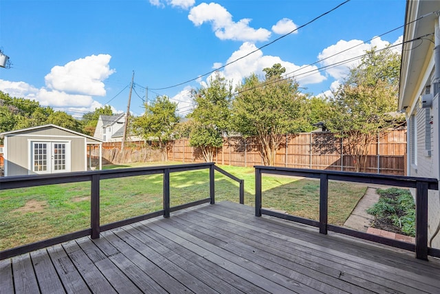 deck with a storage shed and a yard