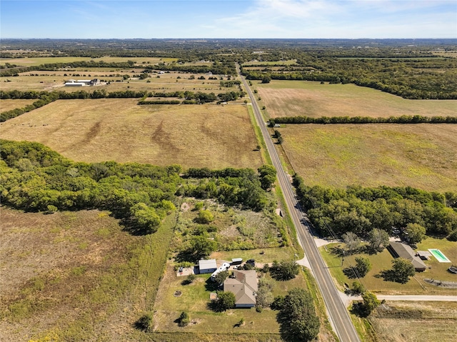 birds eye view of property with a rural view