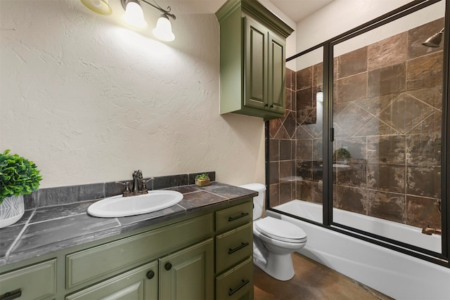 full bathroom with vanity, toilet, and combined bath / shower with glass door