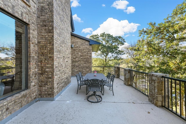 view of patio / terrace with outdoor dining space and a balcony