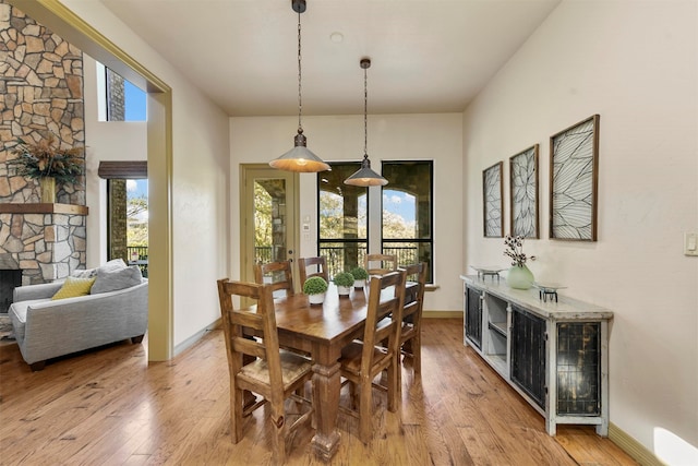 dining area featuring a fireplace and light hardwood / wood-style floors