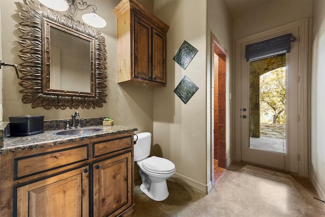 full bathroom with toilet, baseboards, and vanity