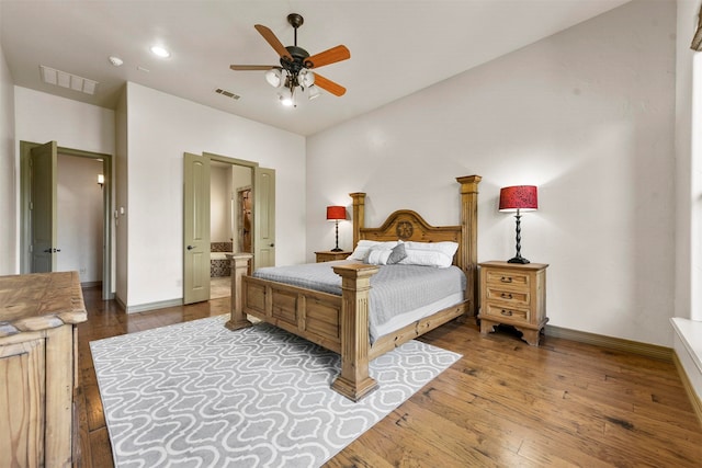 bedroom with ensuite bathroom, dark hardwood / wood-style floors, and ceiling fan