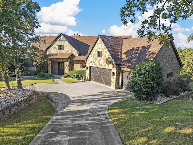 view of front facade with a front yard and a garage