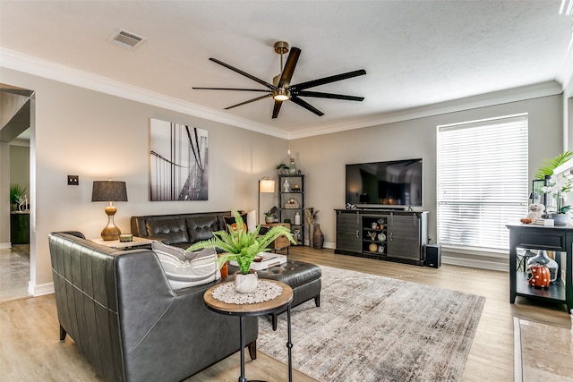 living room with ceiling fan, light hardwood / wood-style flooring, and ornamental molding