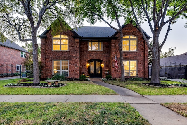 tudor-style house with a front yard