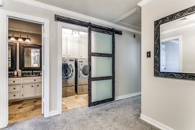 washroom with sink, light colored carpet, crown molding, and washing machine and clothes dryer