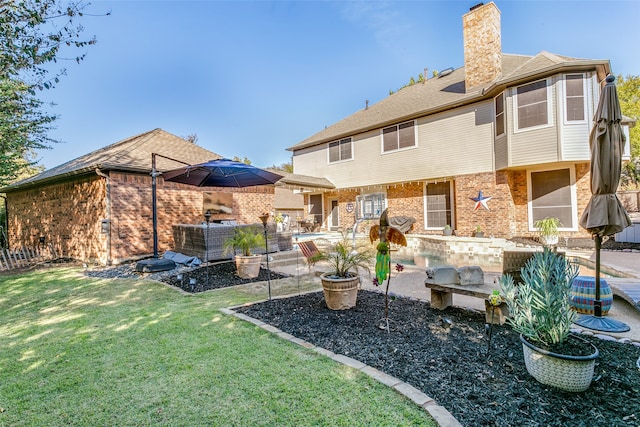 back of property featuring a patio area, a yard, and central AC