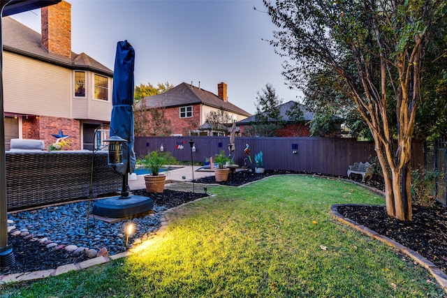 yard at dusk with a patio area and an outdoor hangout area