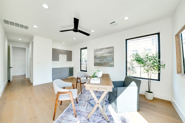 sitting room featuring light wood-type flooring and ceiling fan