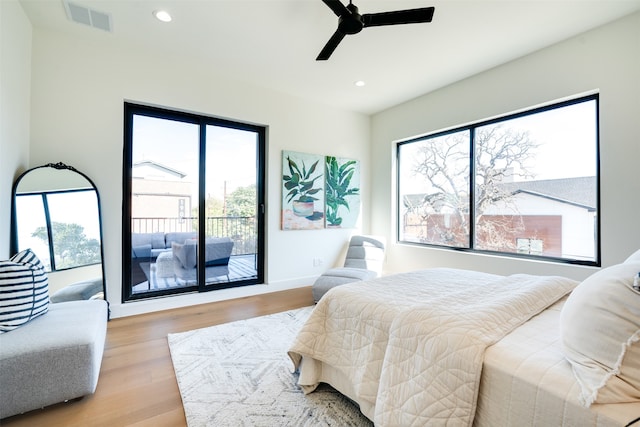 bedroom featuring access to outside, light hardwood / wood-style flooring, and ceiling fan