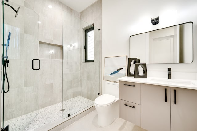 bathroom featuring vanity, a shower with shower door, toilet, and tile patterned flooring