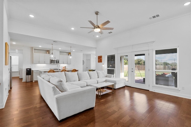 living area with recessed lighting, a ceiling fan, and french doors