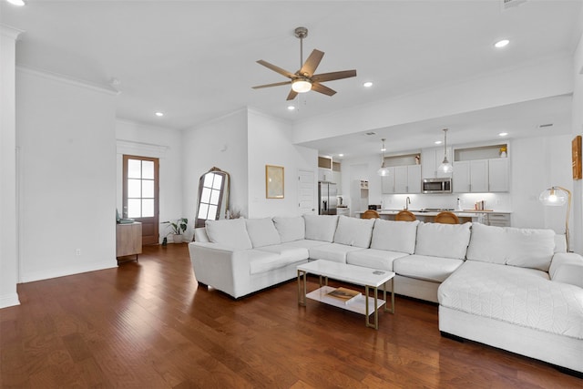 living room featuring ornamental molding, ceiling fan, and dark hardwood / wood-style flooring