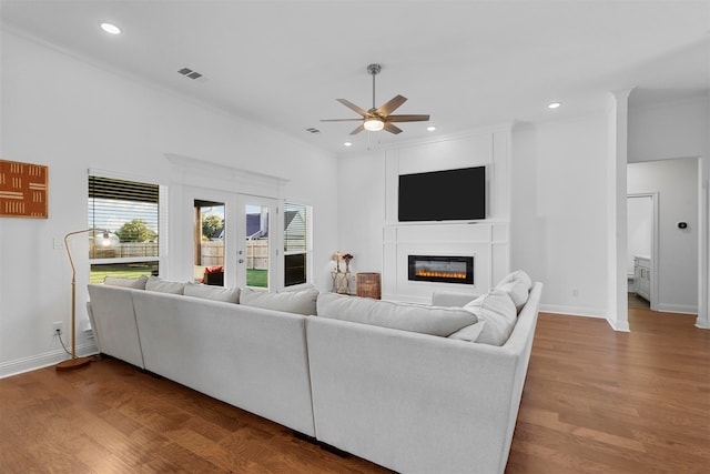 living room featuring crown molding, wood-type flooring, french doors, and ceiling fan