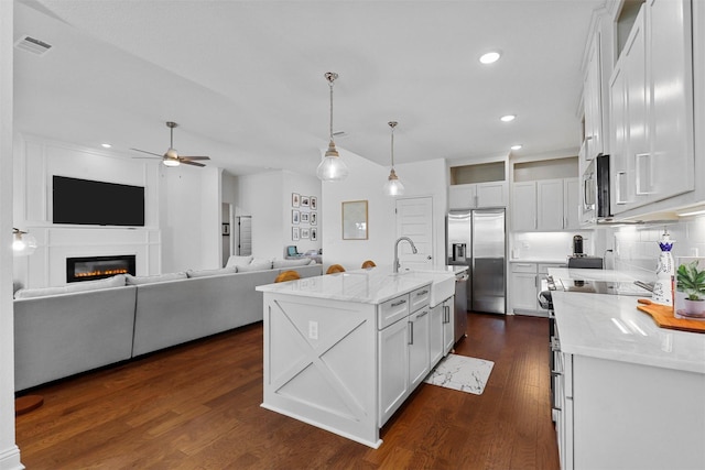 kitchen with recessed lighting, appliances with stainless steel finishes, ceiling fan, a sink, and dark wood-type flooring