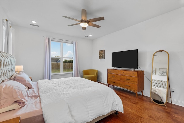 bedroom with recessed lighting, a ceiling fan, visible vents, baseboards, and wood finished floors