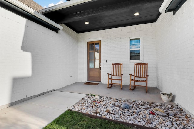 entrance to property with brick siding